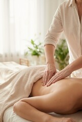 Vertical photo of woman receiving back massage in spa. Professional therapist performing body care treatment. Wellness and health