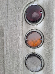 The white minibus has dirty headlights and a dusty rear