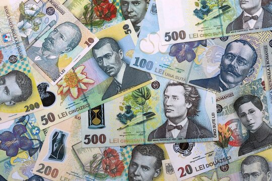 Romanian leu money bills pile on table. Romania banknotes of RON currency close up.