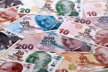 Obraz premium Turkish lira money bills pile on table. Turkey banknotes of TRY currency close up.