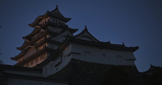 Low shot of shadow and sunset light on 16th century Matsumoto castle