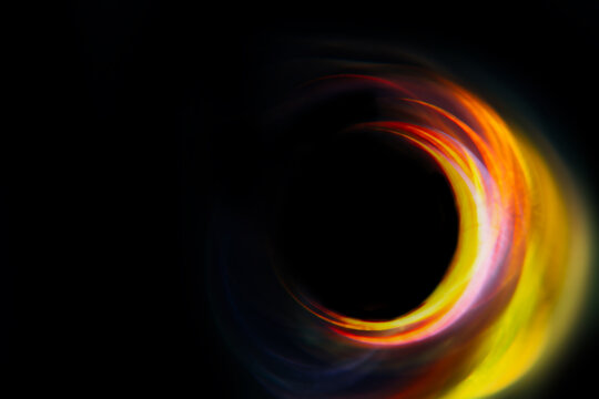semicircular blurred yellow-red glare on a black background