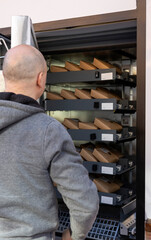 Man collecting package from automated vending machine locker © veronica
