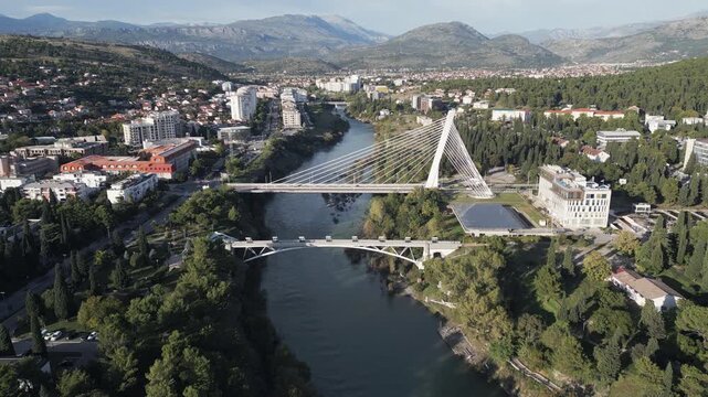 Aerial footage showcases a panoramic view of Podgorica, the largest city and the capital of Montenegro. Flying backwards.