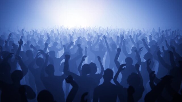 Energetic crowd at a concert with hands in the air, enjoying the music.