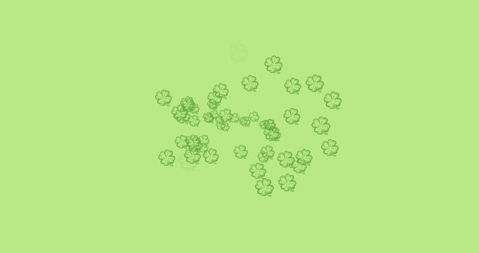 Digital animation of multiple clover leaves forming against green background