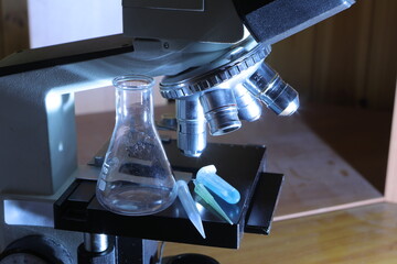 Microscope researching science samples with laboratory equipment