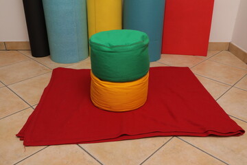 Colorful meditation cushions and yoga mat for wellness