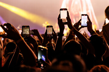 Audience Members Holding up Phones to Film a Live Performance at an Arena © 9parusnikov