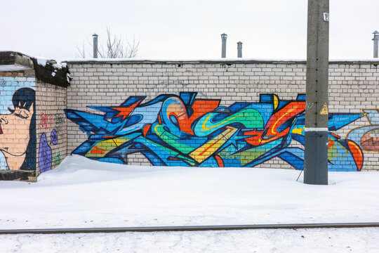 Baranovichi, Brest Region, Belarus - February 11, 2026: Vibrant graffiti art on a brick wall in winter.
