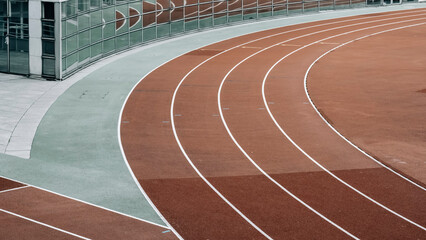 Aerial view of a modern athletics track with lanes and a grandstand