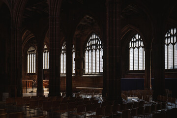 Obraz premium Interior of a historic church with rows of chairs and gothic windows