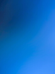 Fototapeta premium The photograph, taken with a camera, has a background color tone of blue and navy. The image contains white with shades of light blue, navy, dark blue, and black, creating a gradient of colors and lig