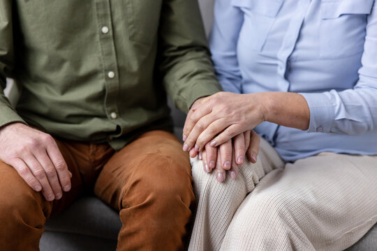 Couple holding hands in a gentle close-up, showing comfort, trust and emotional support between partners intimate connection and caring companionship in everyday life