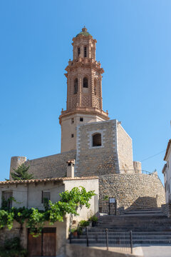 Historic Mudejar tower of Alcudia in the village of Jerica, Castellon, Valencian Community, Spain, against a clear blue sky.