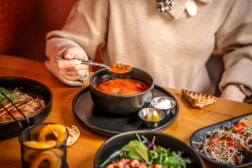Woman Eating Traditional Solyanka Soup At Restaurant