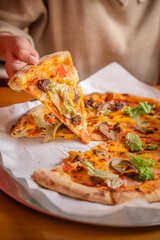Woman Taking Slice Of Fresh Pizza