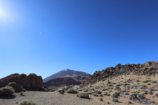 Panoramic view of volcanic rocks and vast arid landscape in Teide National Park Tenerife under clear blue sky. Dramatic nature scenery expressing freedom, solitude and awe. Captured by Canon R6 Mark I