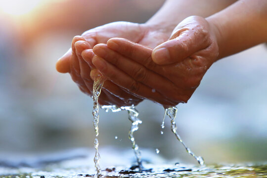 Precious water of life, World Water Day background, drink clear, clean water in your hand.
