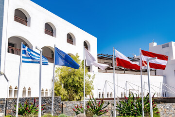 National Greek,blue with stars European Union,Polish,Austrian flags hanging near hotel building house on Crete,Greece.independence or labor day,friendship of countries