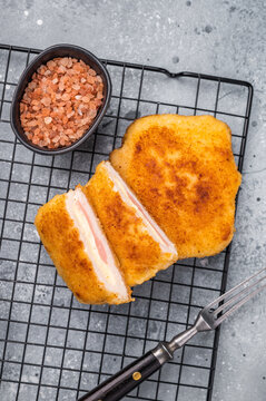Fried Chicken cordon bleu cutlet with cheese and ham in breadcrumbs. grey background. top view