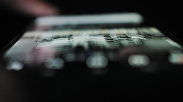 Extreme close-up of a user finger fast scrolling through blurred content on a mobile phone touchscreen. The dark background features an abstract data stream and shallow focus bokeh.