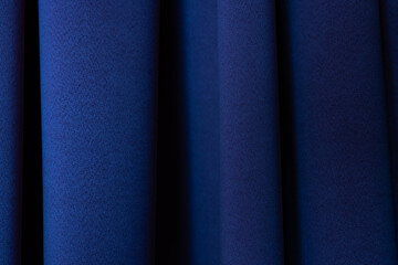Macro Texture of Dark Blue Fabric with Soft Vertical Drapery Folds
