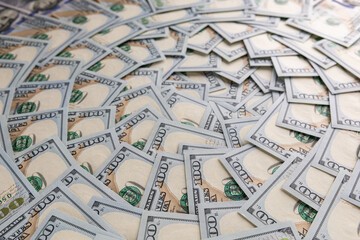 Fototapeta premium Background of Scattered One Hundred US Dollar Bills Representing Wealth and Finance