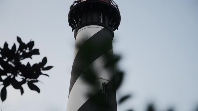 St. Augustine Lighthouse Tower Framed by Tree Leaves