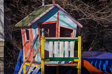 Colorful retro wooden house in children playground outside in park