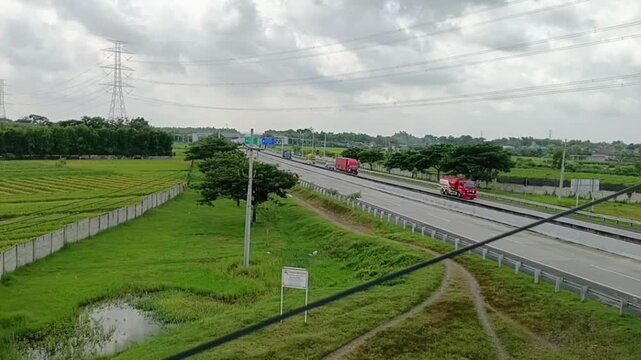 Aerial view of a highway with vehicles moving smoothly and quietly. A toll road with no vehicles.
