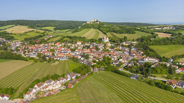 Aerial view of the quaint village nestled among verdant fields, crowned by the imposing Falkenstein Castle, a blend of history and nature, Falkenstein bei Poysdorf, Lower Austria, Austria.