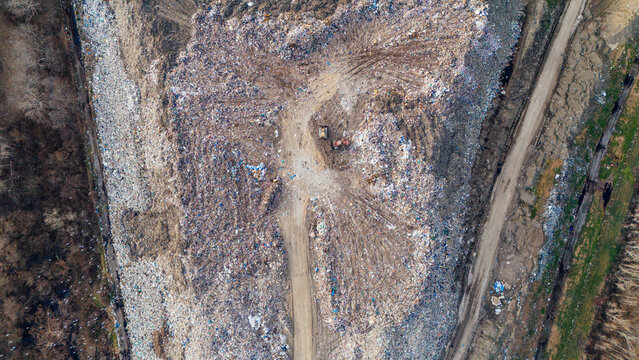 Aerial view of a sprawling landfill, a stark landscape of discarded materials contrasting sharply with the bordering earth, Sremska Mitrovica, Vojvodina, Serbia.