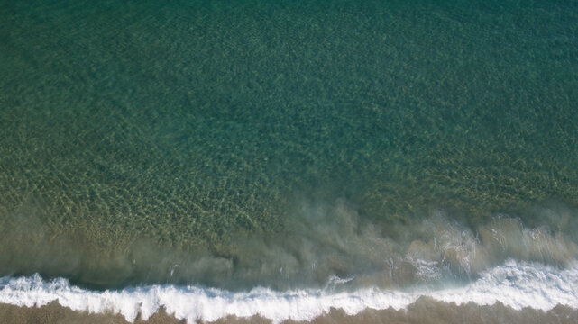 Aerial view of the shoreline where the ocean meets the sand, creating a mesmerizing blend of blues and tans, Rio de Janeiro, State of Rio de Janeiro, Brazil.