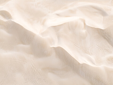 Aerial view of rippling white sand dunes, sculpted by the wind into ethereal forms, creating a stark yet beautiful desert landscape, Lancelin, Western Australia, Australia.