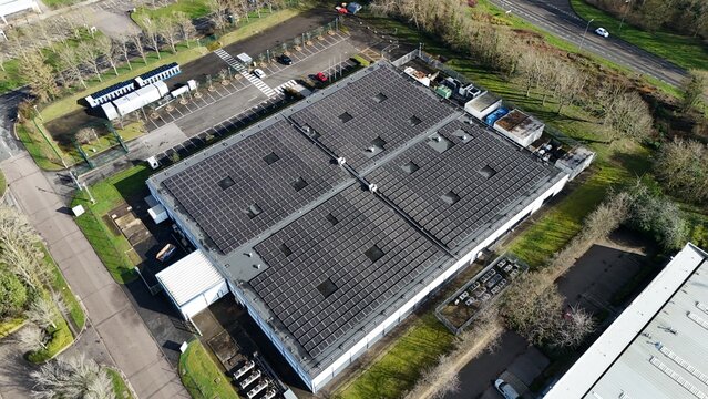 Aerial view of the expansive nLighten Data centre, basking under a winter sun, its rooftop solar panels gleaming against the muted landscape, Milton Keynes, United Kingdom.