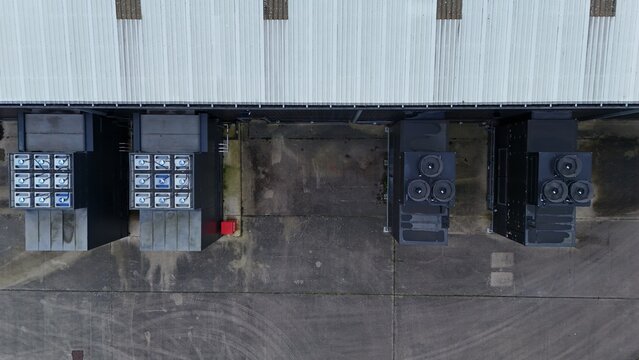 Aerial view of the Node4 Data Centre, with stark contrasts between the metallic roof and the dark, imposing server units below, Northampton, United Kingdom.