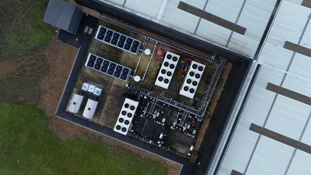 Aerial view of a Node4 Data Centre with visible cooling systems and pipes on a flat roof, Northampton, United Kingdom.