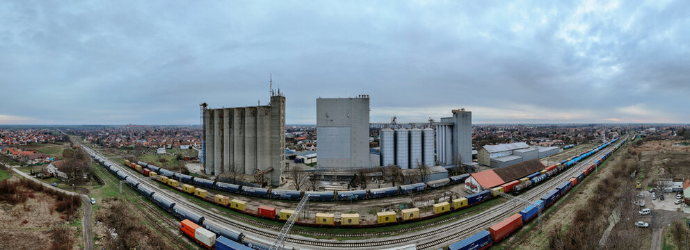 Aerial view of the industrial zone, where grain elevators stand tall against the skyline, with trains awaiting their cargo, Sremska Mitrovica, Vojvodina, Serbia.