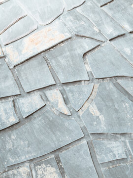 Aerial view of stone pavement creating a mosaic of textures and tones, where the gray and light hues blend seamlessly, Sicilia, Italy.