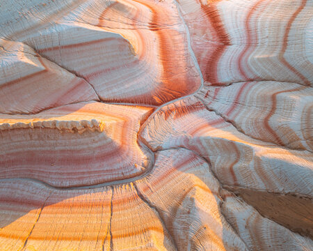 Aerial view of the striking geological formations with layered patterns of beige and terracotta hues, sculpted by time and elements, Kyzylkum, Mangystau Region, Kazakhstan.