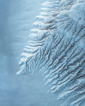 Aerial view of the desolate, textured landscape, with its intricate patterns and stark contrasts, resembling an otherworldly terrain, Mangystau Region, Kazakhstan.