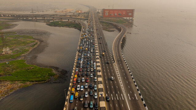 Aerial view of the Third Mainland Bridge choked with dense traffic, reflecting the stark contrast between the urban sprawl and natural waterways, Lagos, Lagos, Nigeria.