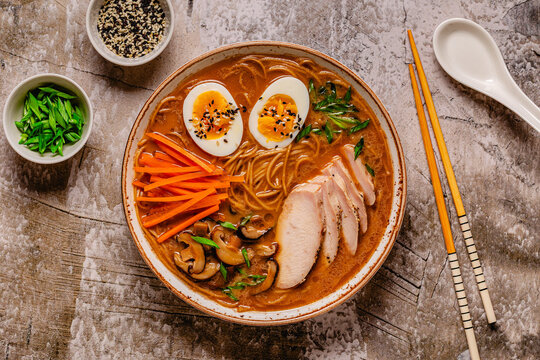 Bowl of ramen with chicken, eggs, and vegetables