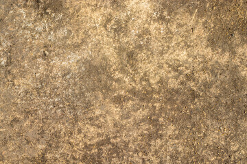 Rough earthy textured background resembling weathered stone, featuring brown and beige tones, irregular stains, granular surface, and rustic aged appearance.
