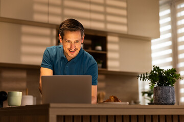 Cheerful Man Doing Work On Laptop