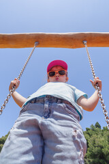 Girl playing on the swing