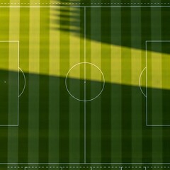 Aerial View of a Soccer Field with Striped Grass and Goalposts.