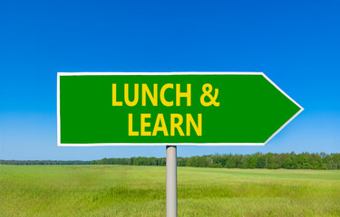 Lunch and learn symbol. Concept words Lunch and learn on beautiful green road sign. Beautiful blue sky green grass field background. Business, educational and lunch and learn concept. Copy space.