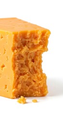 Sharp Cheddar Cheese Chunk with Bite Mark on White Background.